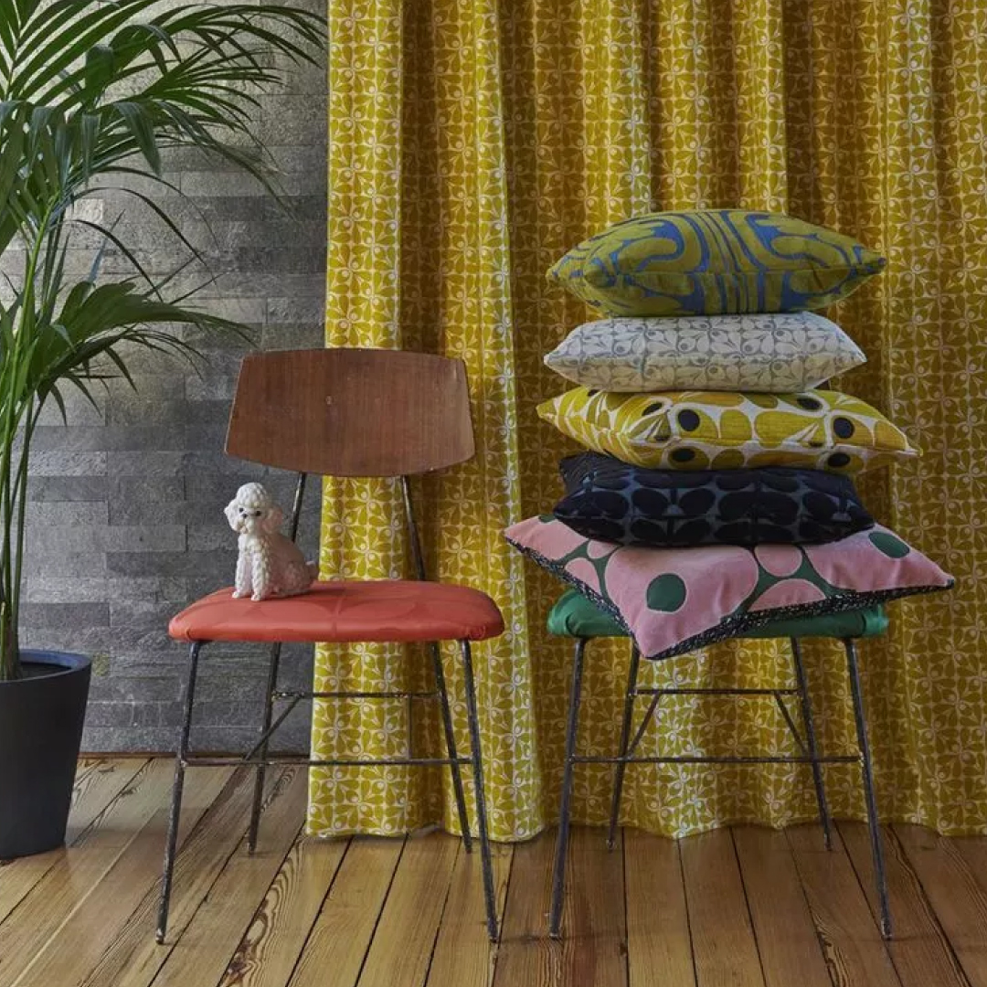 orla kiely retro curtains behind a selection of designer  cushions 